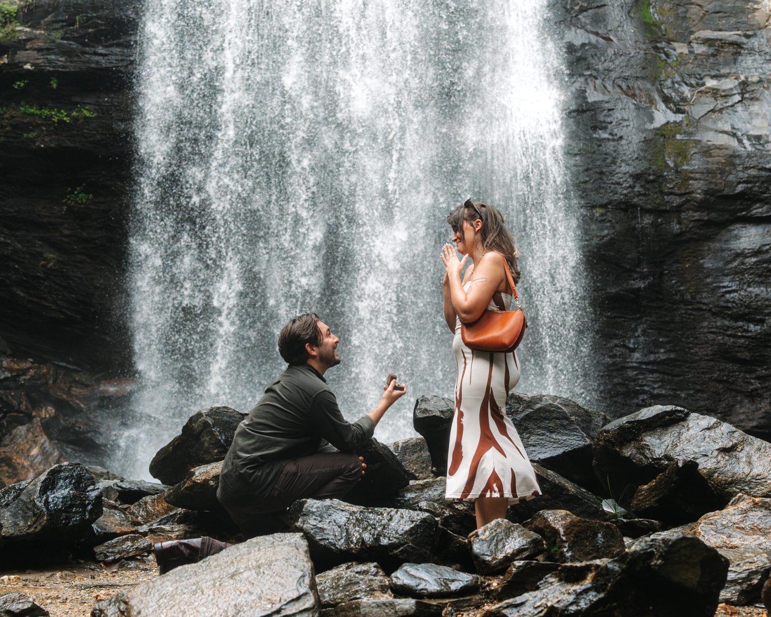 Surprise proposal on the rocks beneath Looking Glass Falls in Brevard, North Carolina